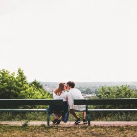 Couple enjoying a romantic moment at Lookout Park with downtown Grand Rapids in the distance