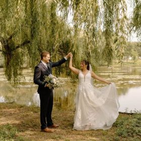 Bride and groom dancing together at Riverside Park in Grand Rapids, MI